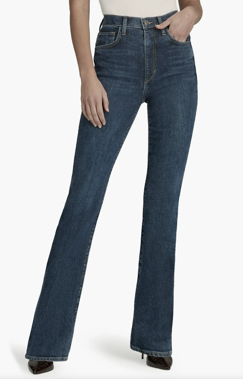 Product view of dark wash Favorite Daughter Valentina super high-waist mini bootcut jeans styled with dark brown pointed-toe boots.