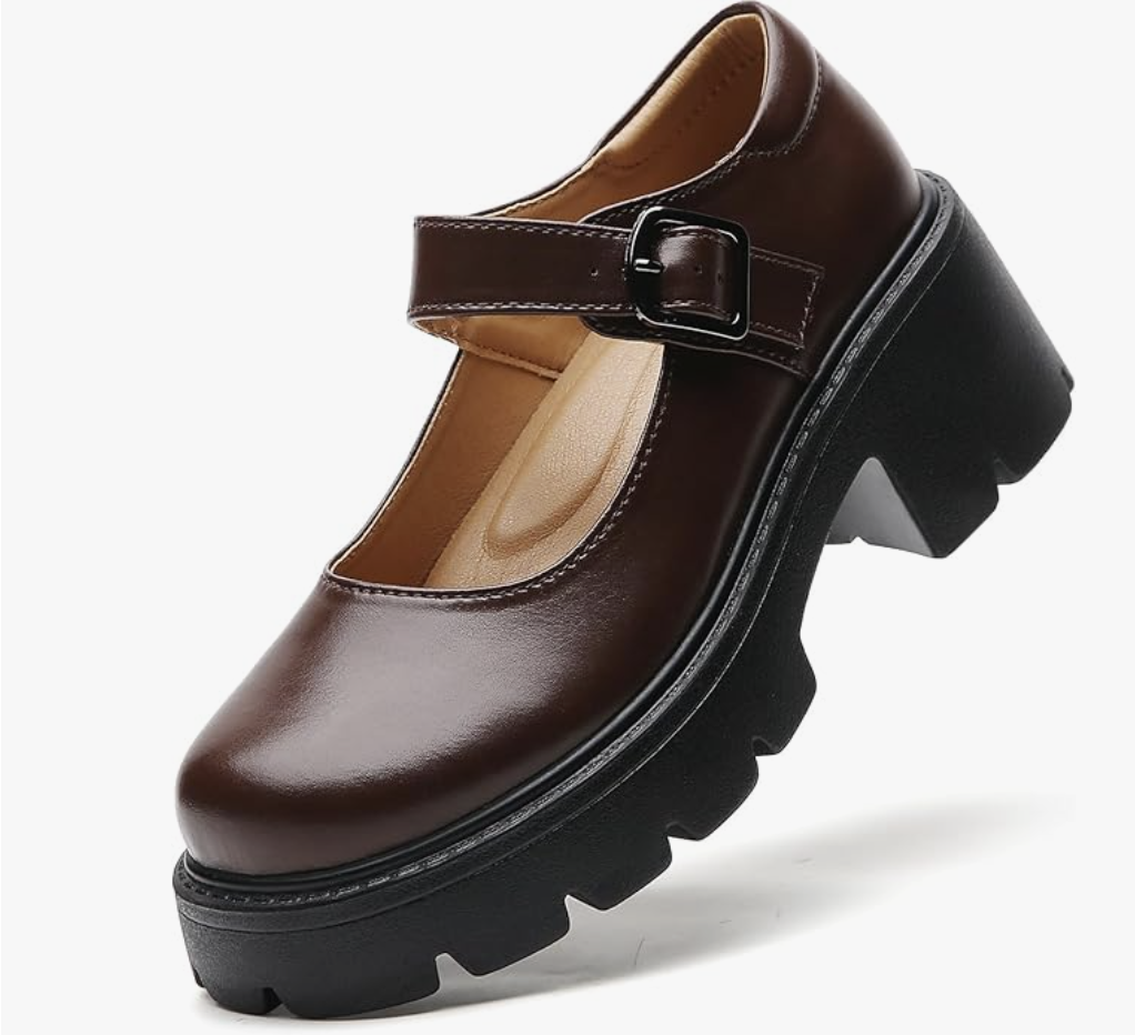 A pair of dark brown faux leather platform Mary Jane flats for women featuring a thick lug sole, a round toe, and a single strap with a silver buckle.