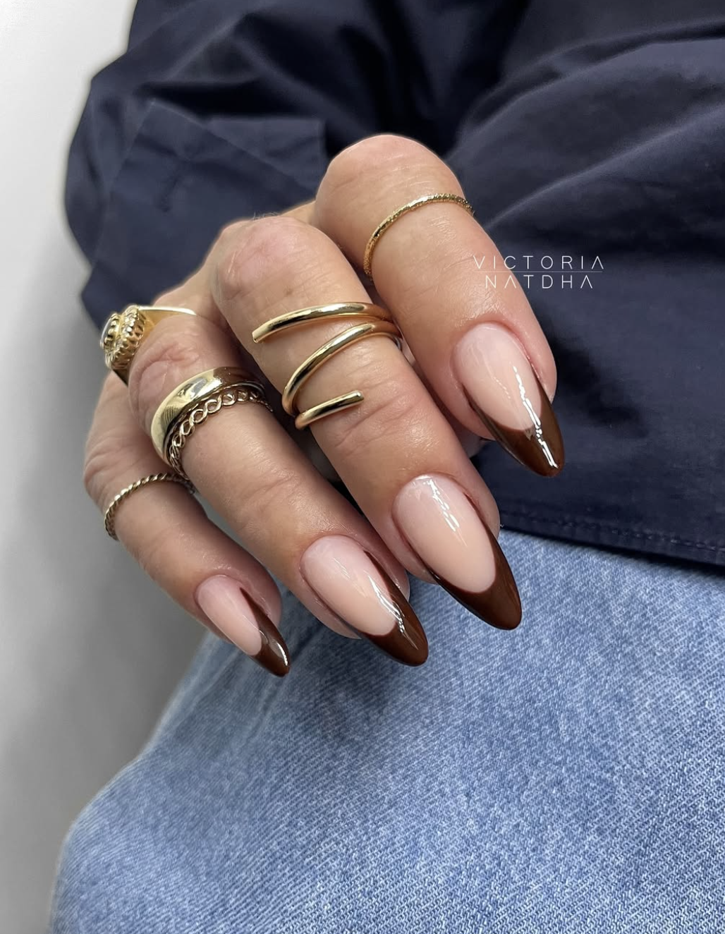 Close-up of chocolate-brown almond french on neatly manicured hands