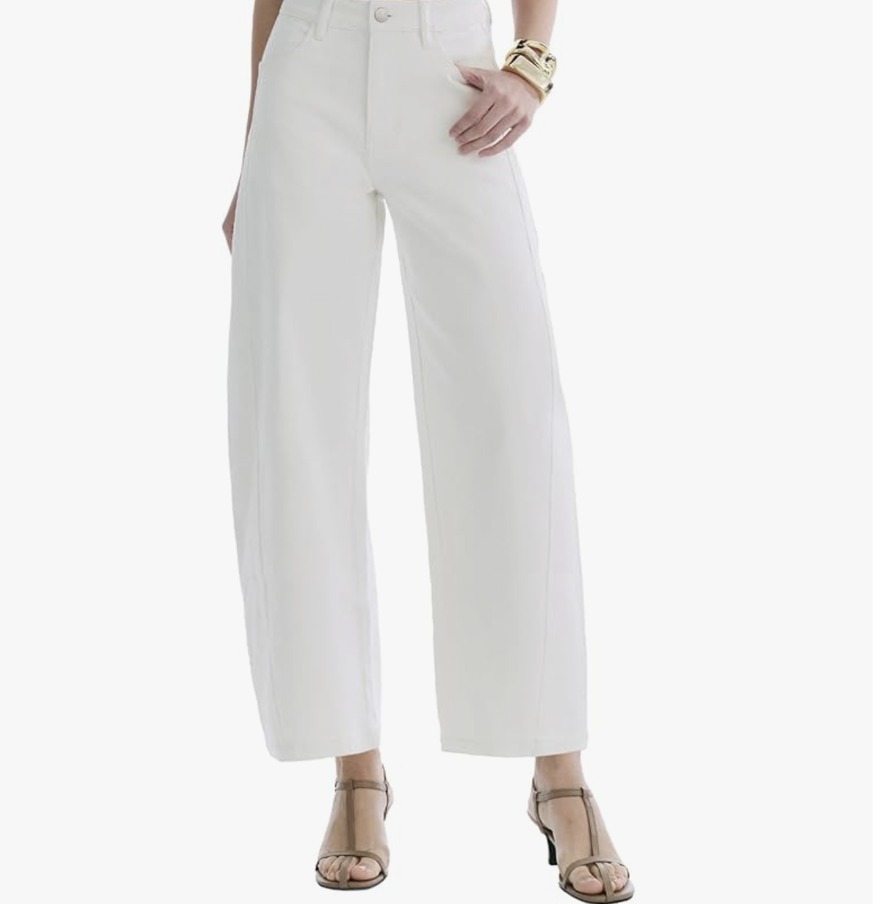 Front view of a person wearing high-waisted wide-leg trousers in white styled with gold cuff bracelets and neutral heeled sandals against a white background.
