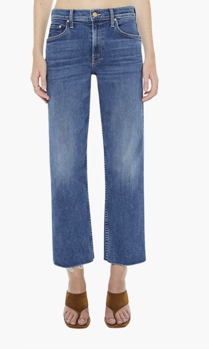 A tan suede slip-on mule for women by Jenni Kayne, featuring a pointed toe, a single strap with a gold buckle, and a plush cream shearling lining.