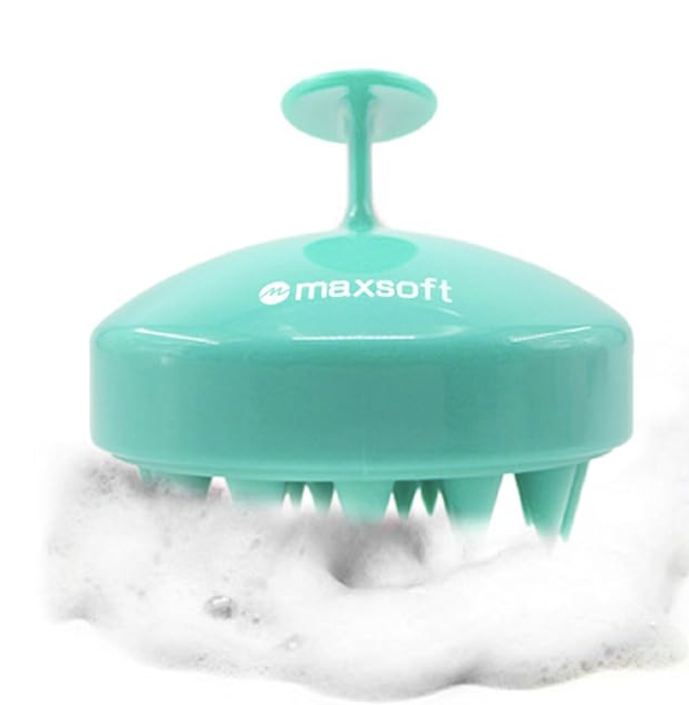 A mint green Maxsoft Hair Scalp Massager with soft silicone bristles shown in a lather of shampoo suds, ideal for sensitive or color-treated hair.