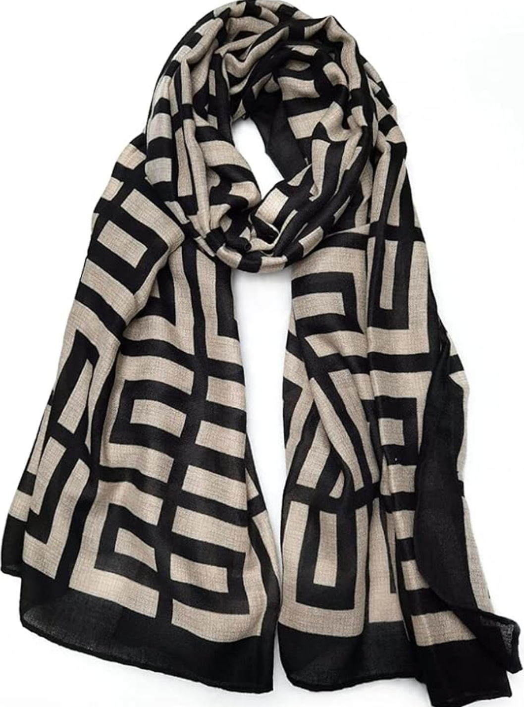 Close-up of a lightweight, sheer cream scarf featuring a bold black geometric tile and border print, laid out flat.
