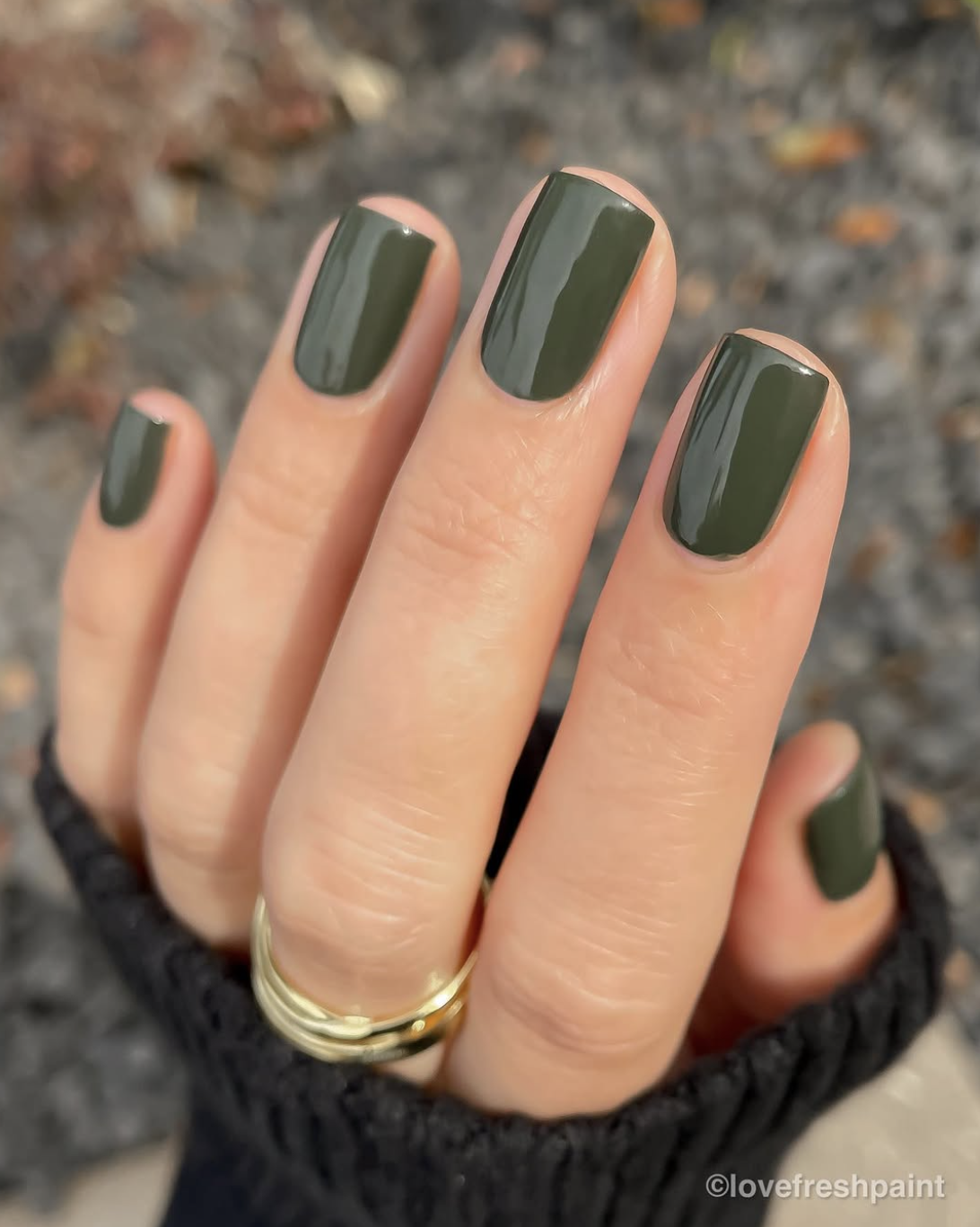 Short squoval nails painted a glossy smoky olive green for fall.