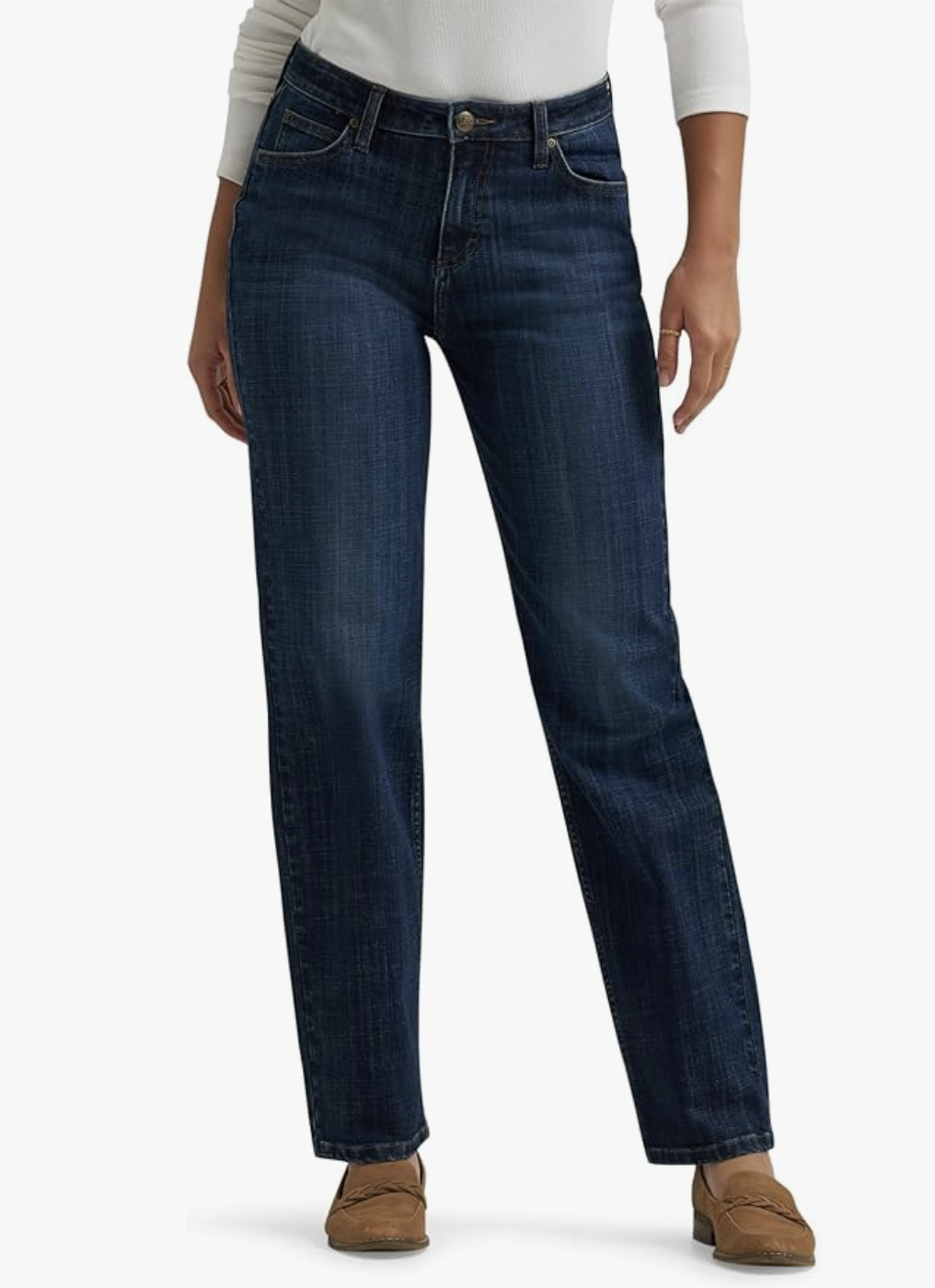 Model wearing Levi's 311 Shaping Skinny Jeans in a dark indigo wash, featuring a tummy-slimming panel and high-stretch denim that contours to an athletic or rectangle figure, styled with brown loafers.