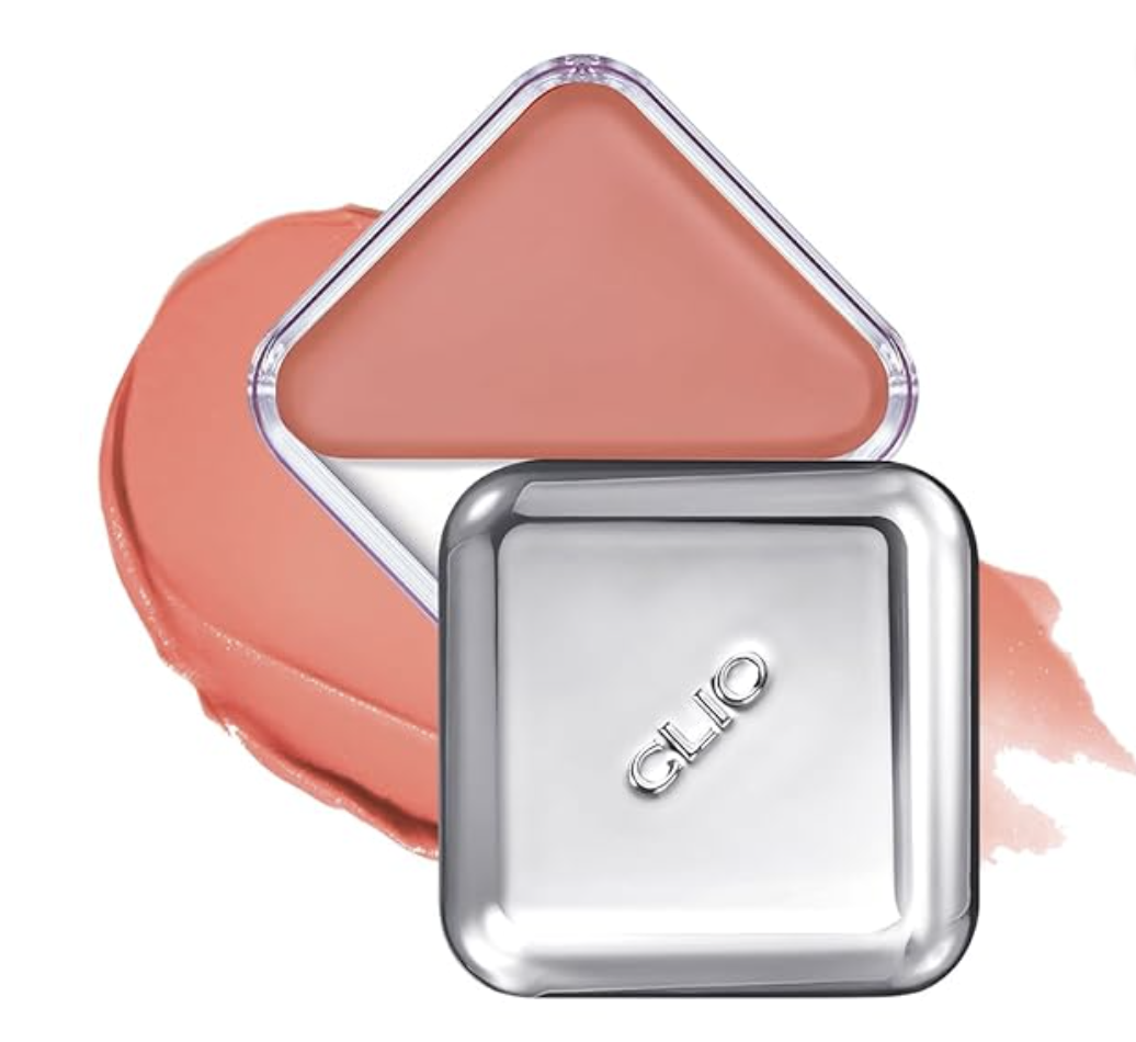 A close-up view of a sleek square cream blush compact shown next to a smooth, textured swipe of peachy-coral cream blush pigment.