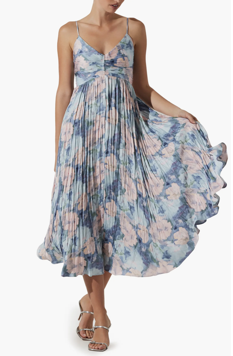A woman wearing the ASTR the Label Maeve Midi Dress in a blue and pink floral print with a pleated skirt and thin straps.
