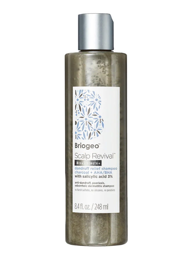 A tub of Briogeo Scalp Revival Charcoal + Coconut Oil Micro-Exfoliating Shampoo being applied to a scalp to treat buildup and itching.