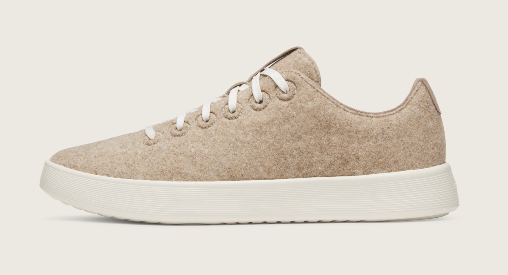 A pair of off-white Allbirds Wool Cruiser sneakers, a sustainable and cozy option for professional work sneakers in a business-casual office.