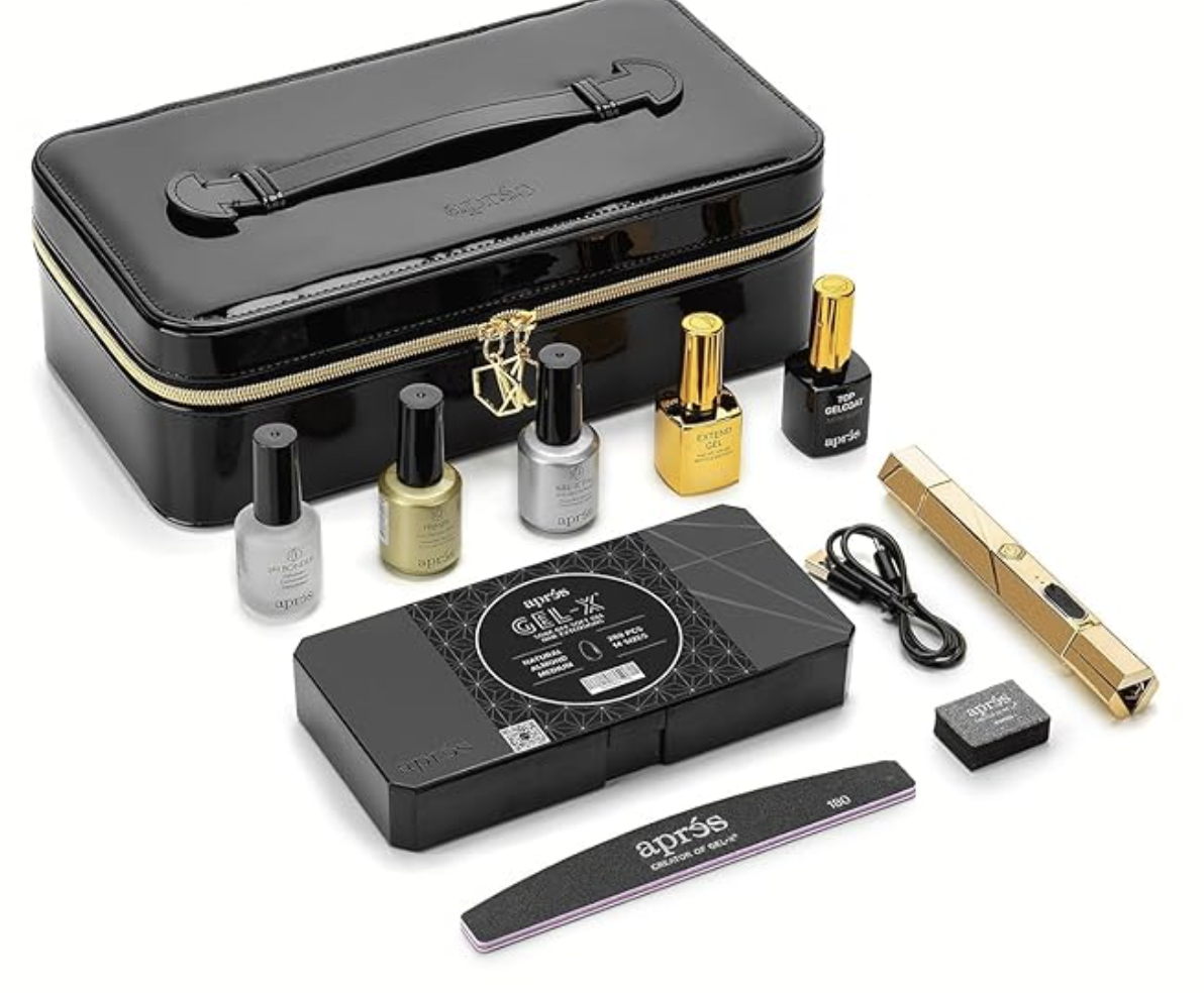 An Aprés Gel-X Signature Starter Kit featuring soft gel nail extensions, a professional LED lamp, prep tools, and a black travel storage case