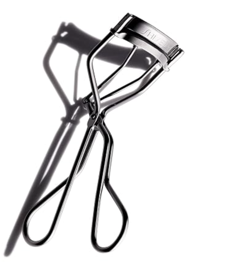 Shiseido metal eyelash curler with replacement pad.