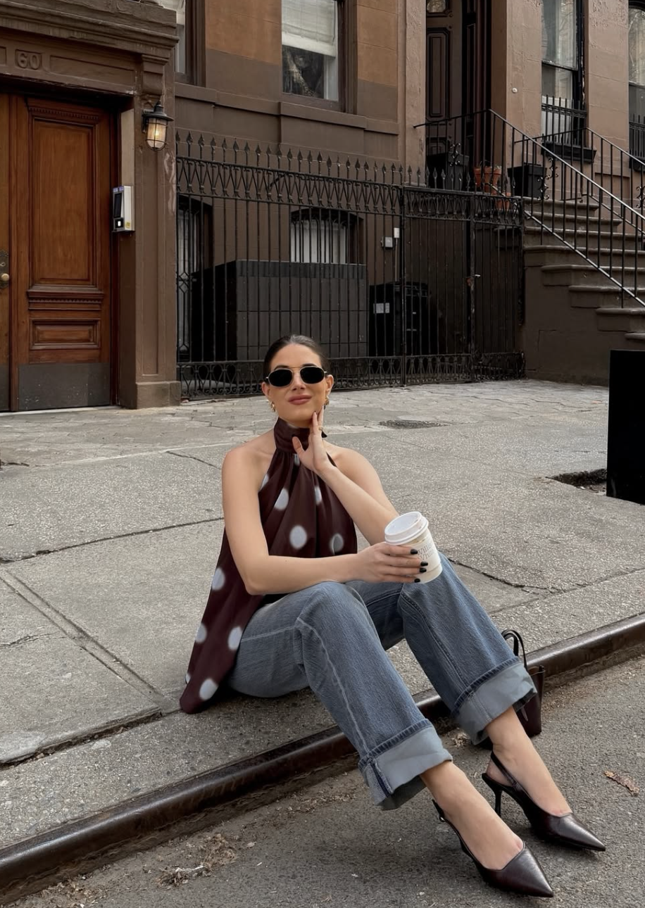 woman wearing a brown polka dot halter top with wide leg jeans — casual summer polka dot outfit with denim