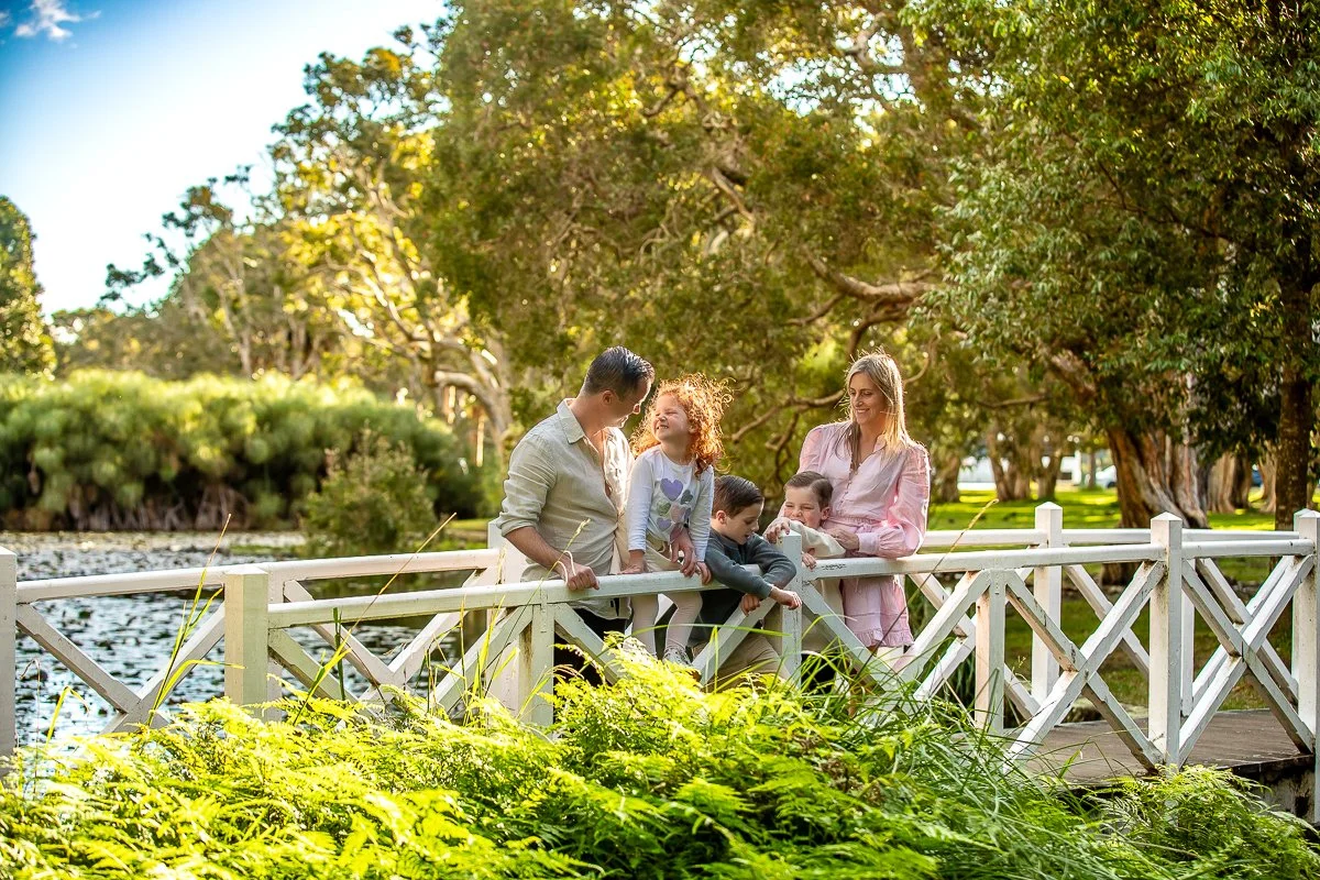 A family on the bridge in the afternoon sun at Centennial Park in Sydney's eastern suburbs for a family photoshoot