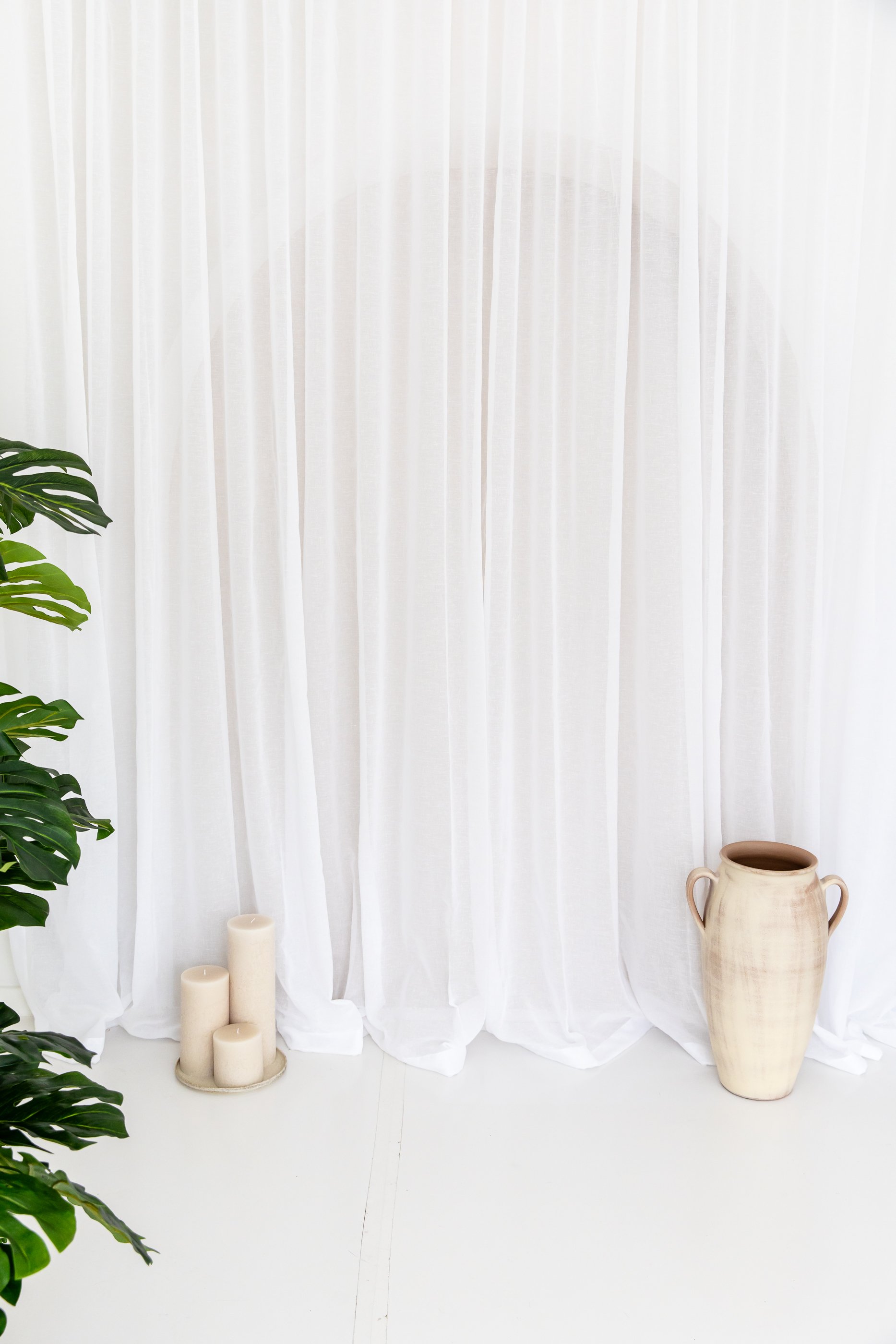sheer curtain with candles, pot and plant