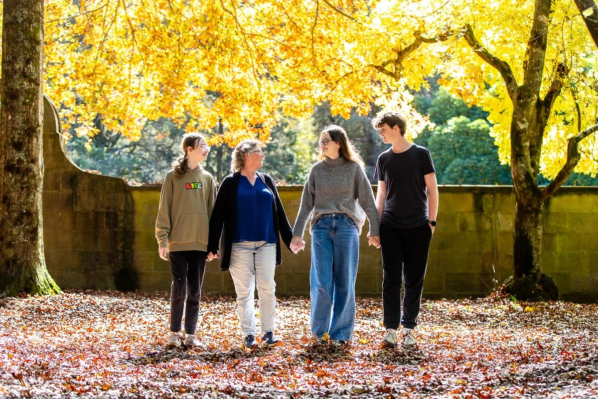 A family in the gorgeous autumn colours at Breenhold Gardens in Mount Wilson in the Blue Mountains during a family photoshoot