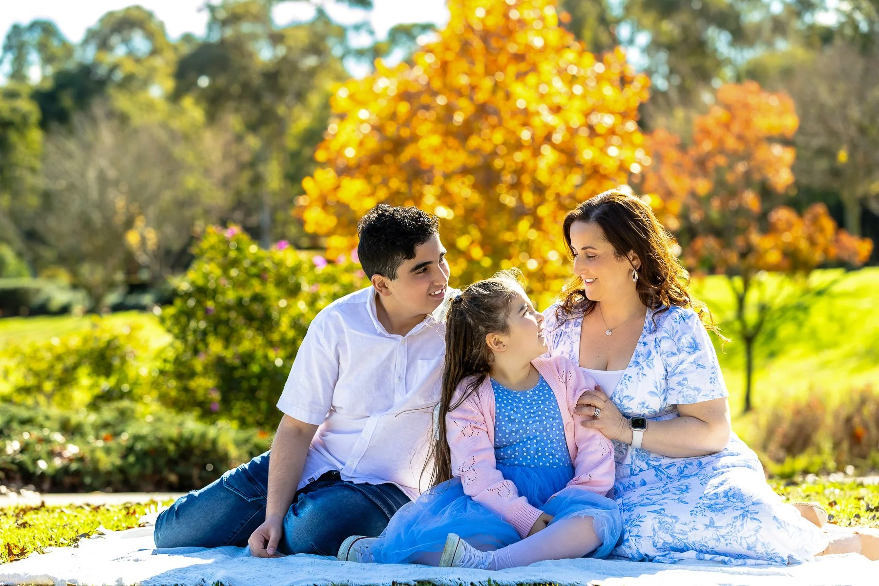 A family at Nurragingy Reserve in Sydney's Western Suburbs for a family photoshoot during the stunning colours of autumn