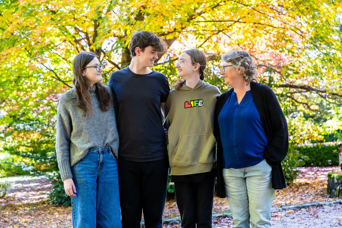 A family in the gorgeous autumn colours at Breenhold Gardens in Mount Wilson in the Blue Mountains during a family photoshoot