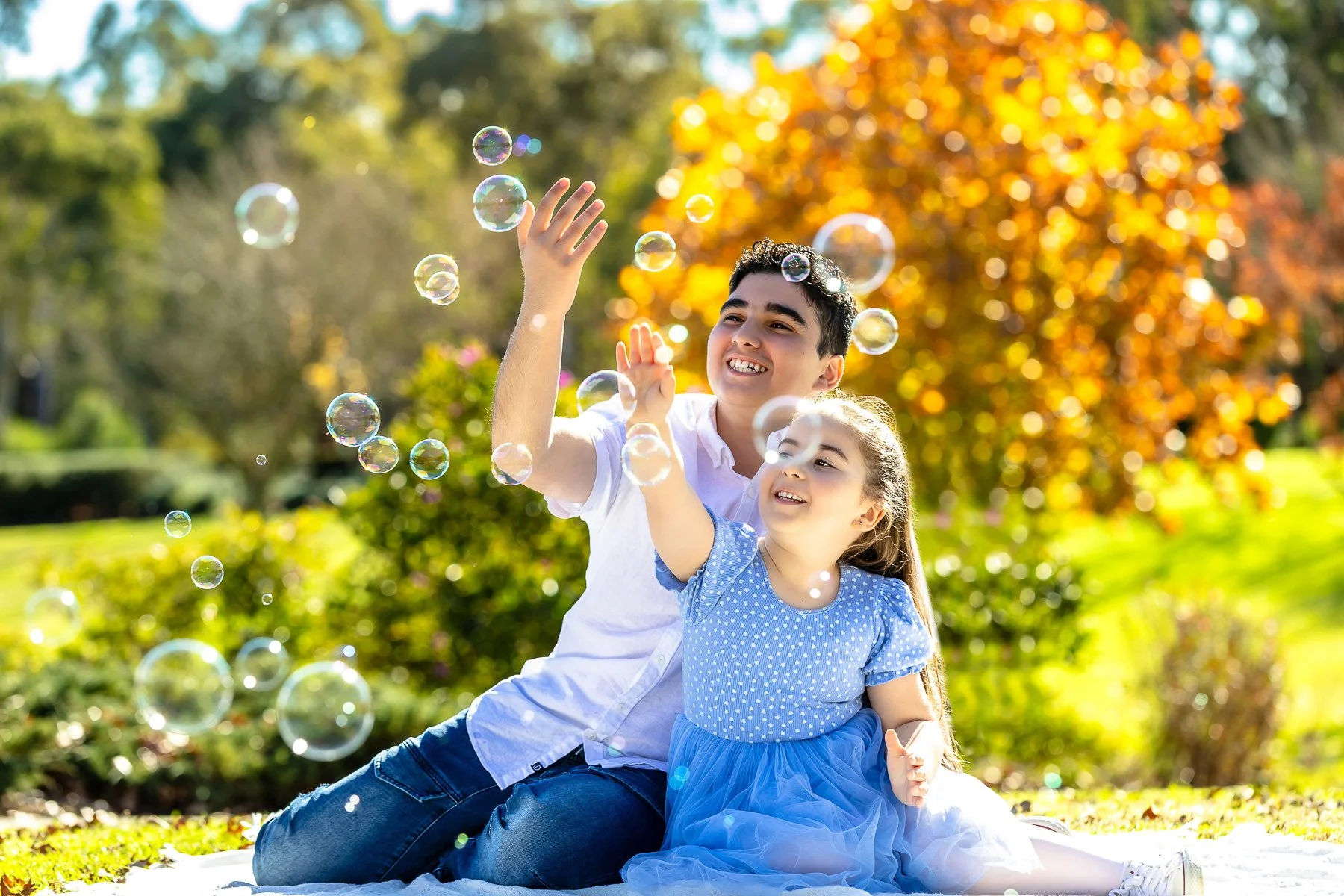 A family at Nurragingy Reserve in Sydney's Western Suburbs for a family photoshoot during the stunning colours of autumn