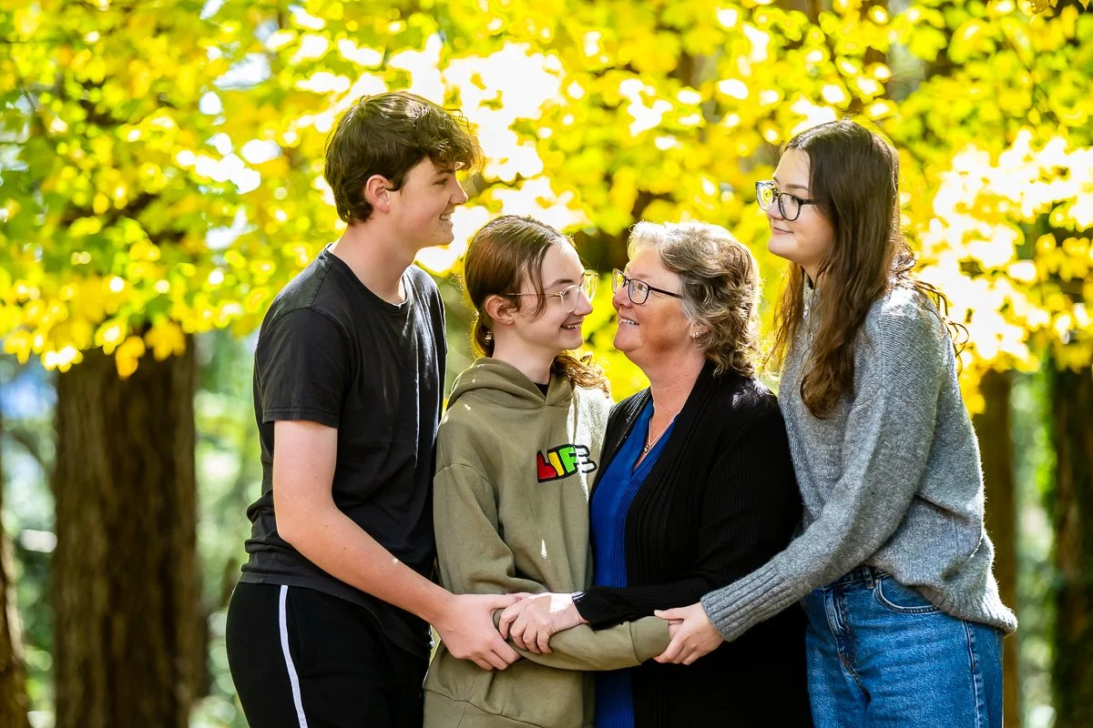A family in the gorgeous autumn colours at Breenhold Gardens in Mount Wilson in the Blue Mountains during a family photoshoot