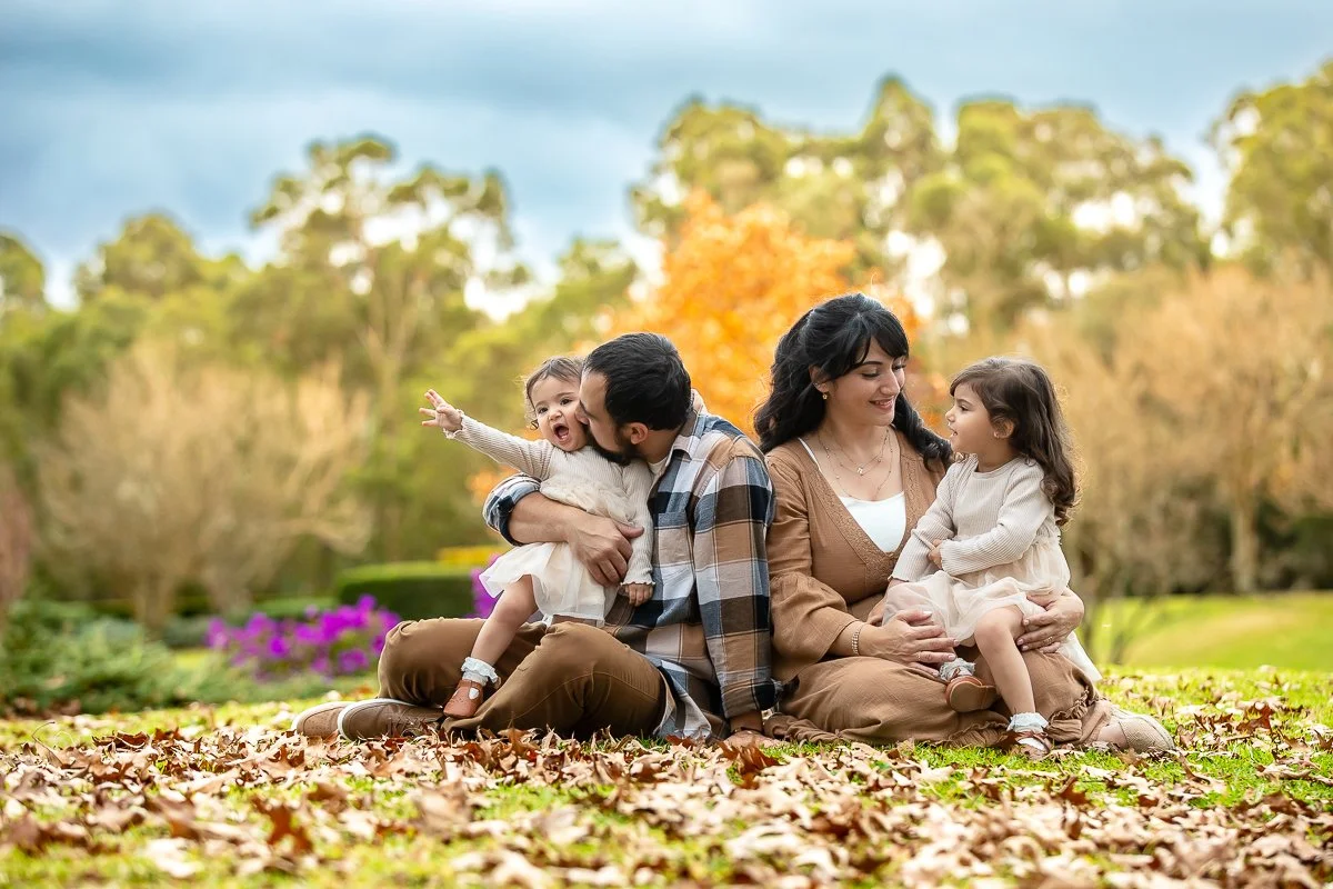 A family at Nurragingy Reserve in Sydney's Western Suburbs for a family photoshoot during the stunning colours of autumn