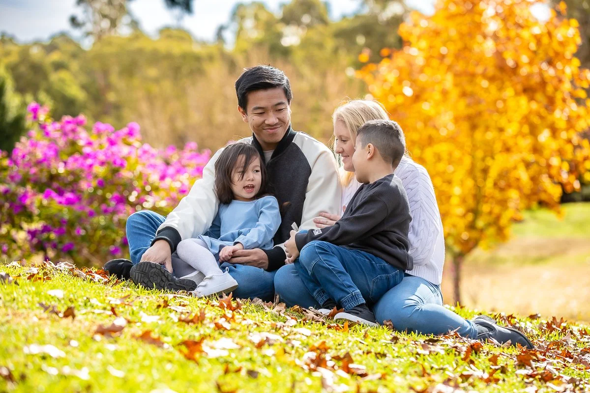 A family at Nurragingy Reserve in Sydney's Western Suburbs for a family photoshoot during the stunning colours of autumn