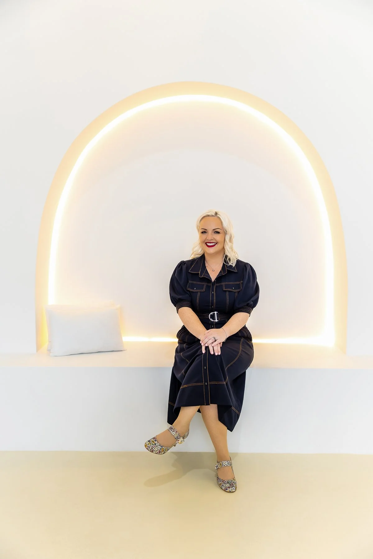 A woman sitting on the arch section of Solis Studio Sydney in Riverwood for her branding photography session with Captured by Kirri