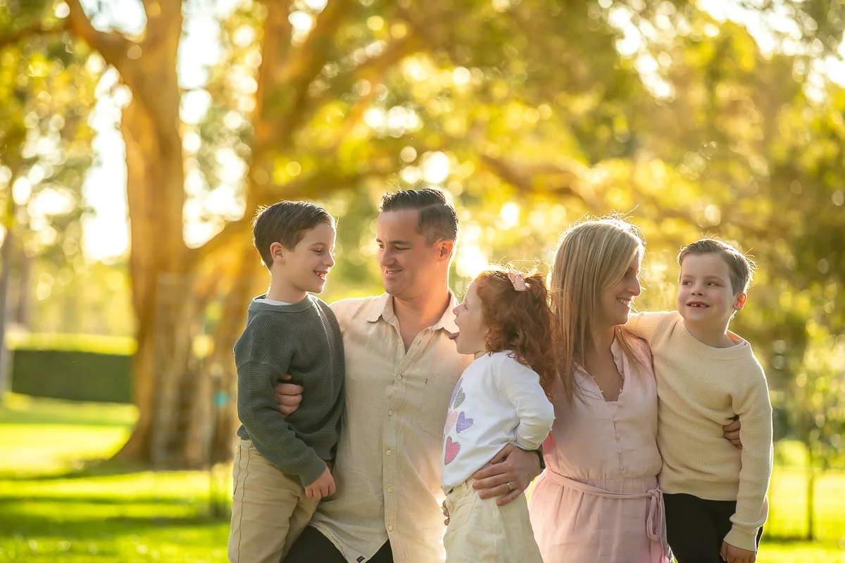A family in the afternoon sun at Centennial Park in Sydney's eastern suburbs for a family photoshoot