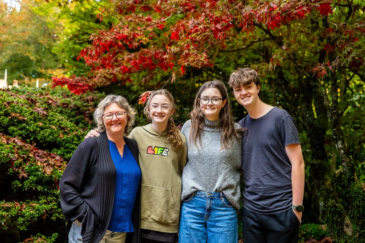 A family in the gorgeous autumn colours at Breenhold Gardens in Mount Wilson in the Blue Mountains during a family photoshoot