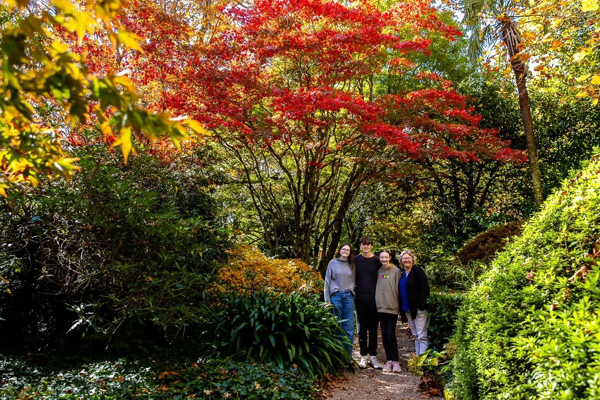 A family together in the autumn colours of Bebeah Gardens during a family photoshoot