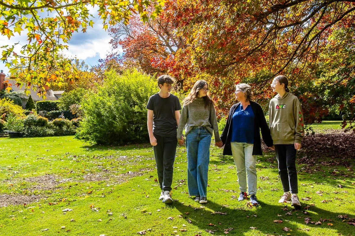 A family in the gorgeous autumn colours at Breenhold Gardens in Mount Wilson in the Blue Mountains during a family photoshoot