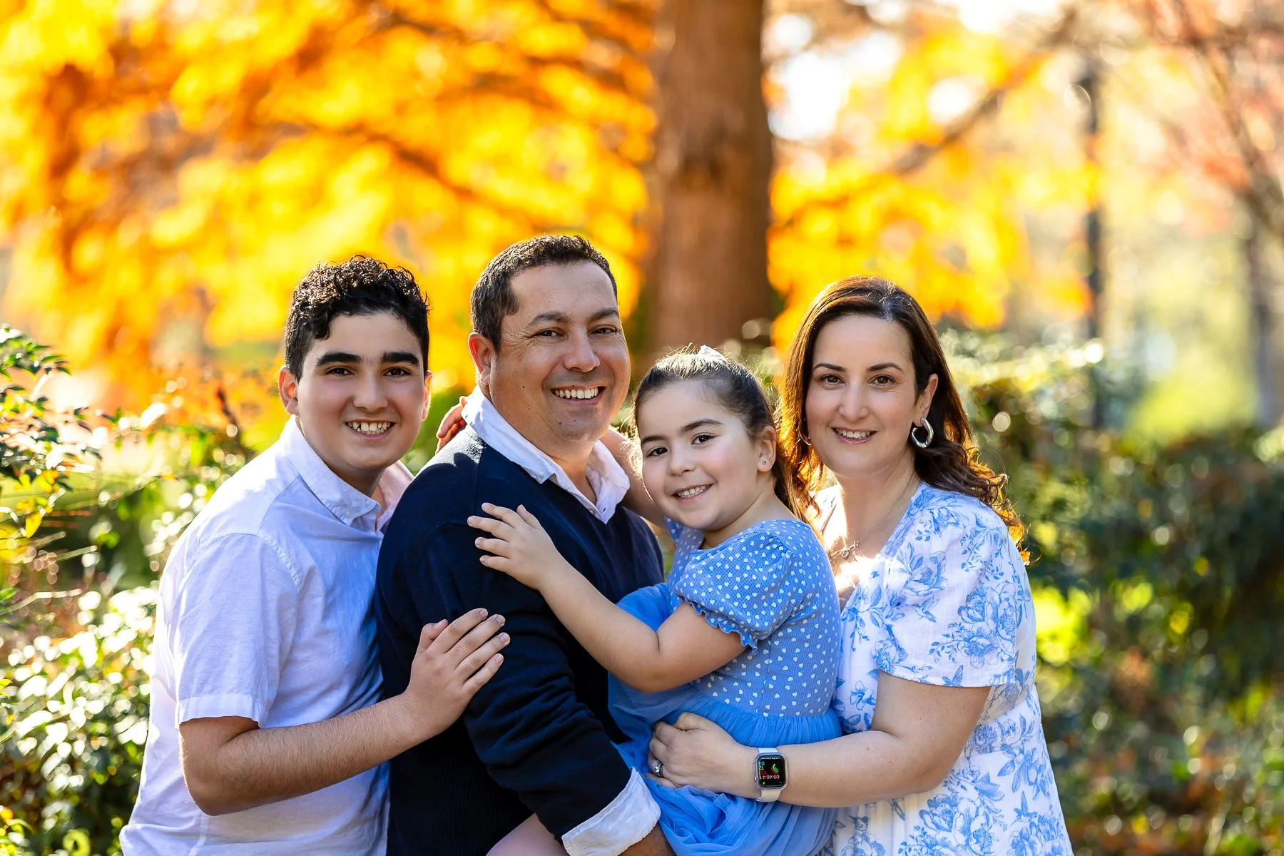 A family at Nurragingy Reserve in Sydney's Western Suburbs for a family photoshoot during the stunning colours of autumn