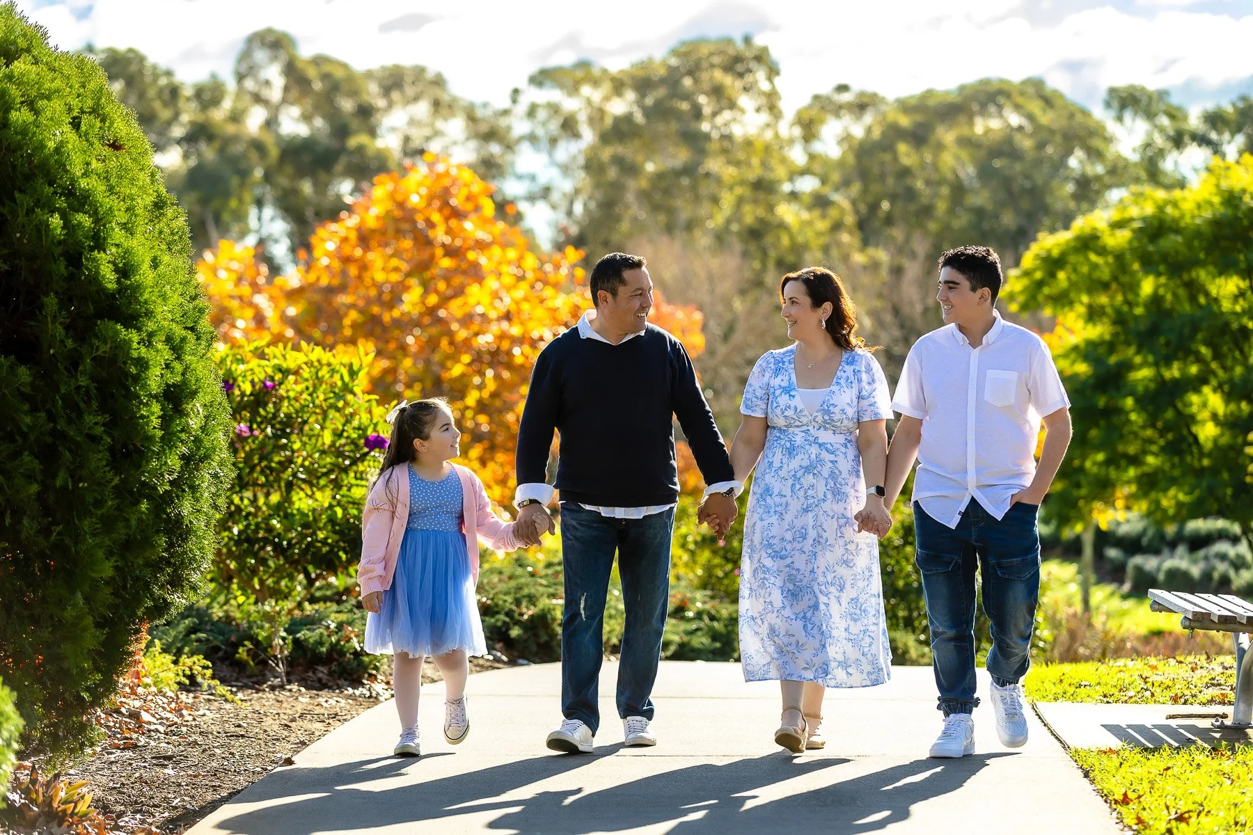 A family at Nurragingy Reserve in Sydney's Western Suburbs for a family photoshoot during the stunning colours of autumn