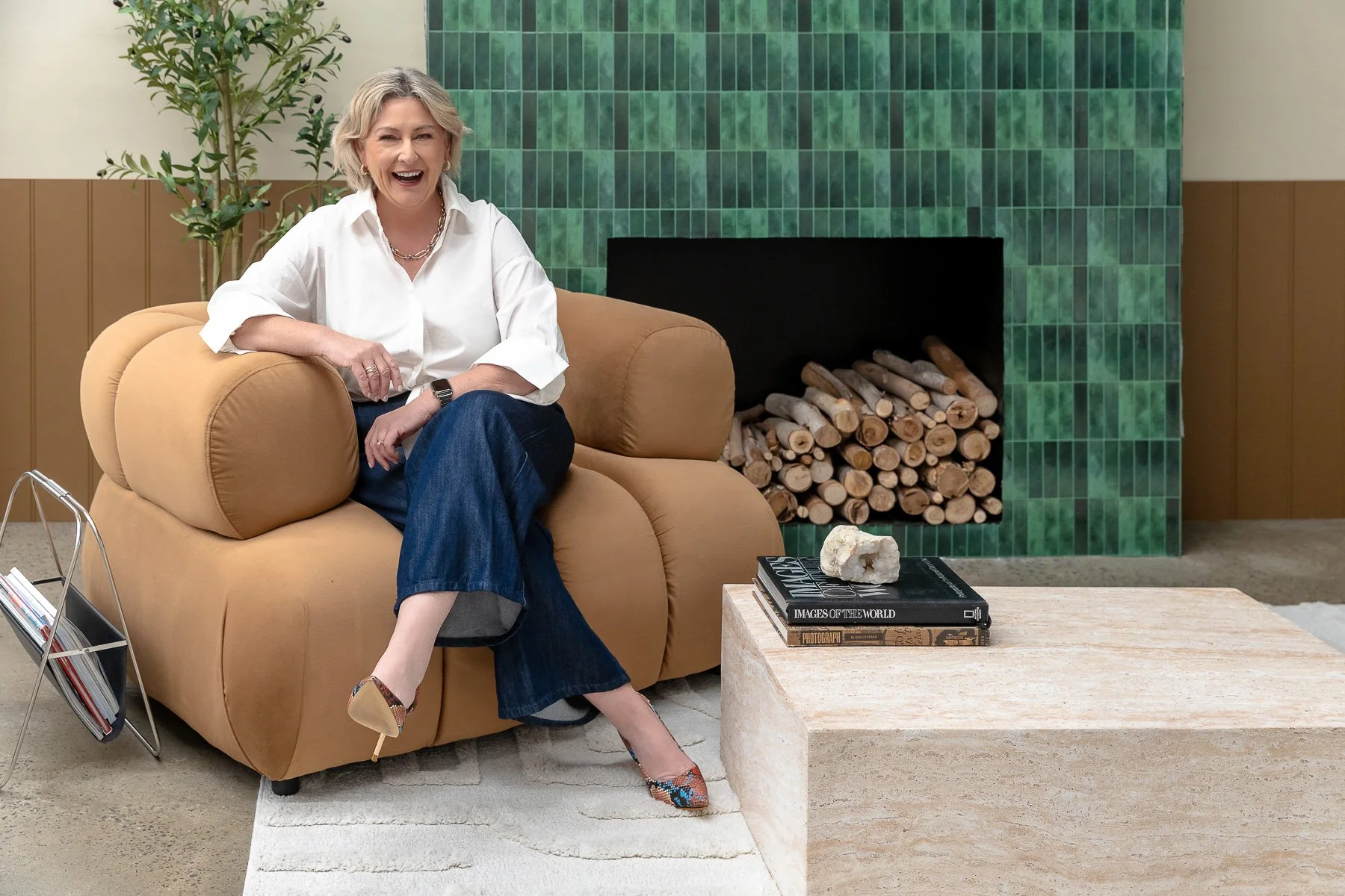 Stunning green fireplace with wood and large brown couch makes for fantastic branding photography at Different Agency in Alexandria Sydney