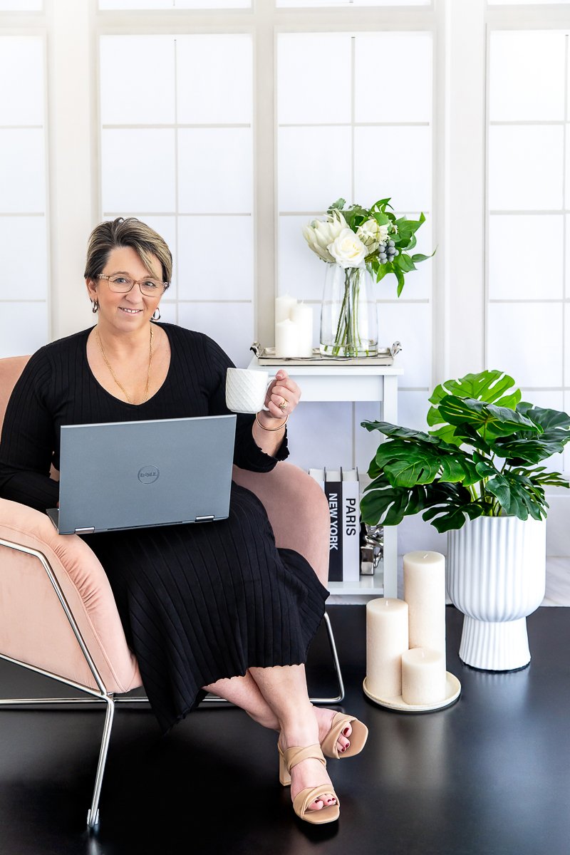 lady sitting in a chair with her laptop and coffee