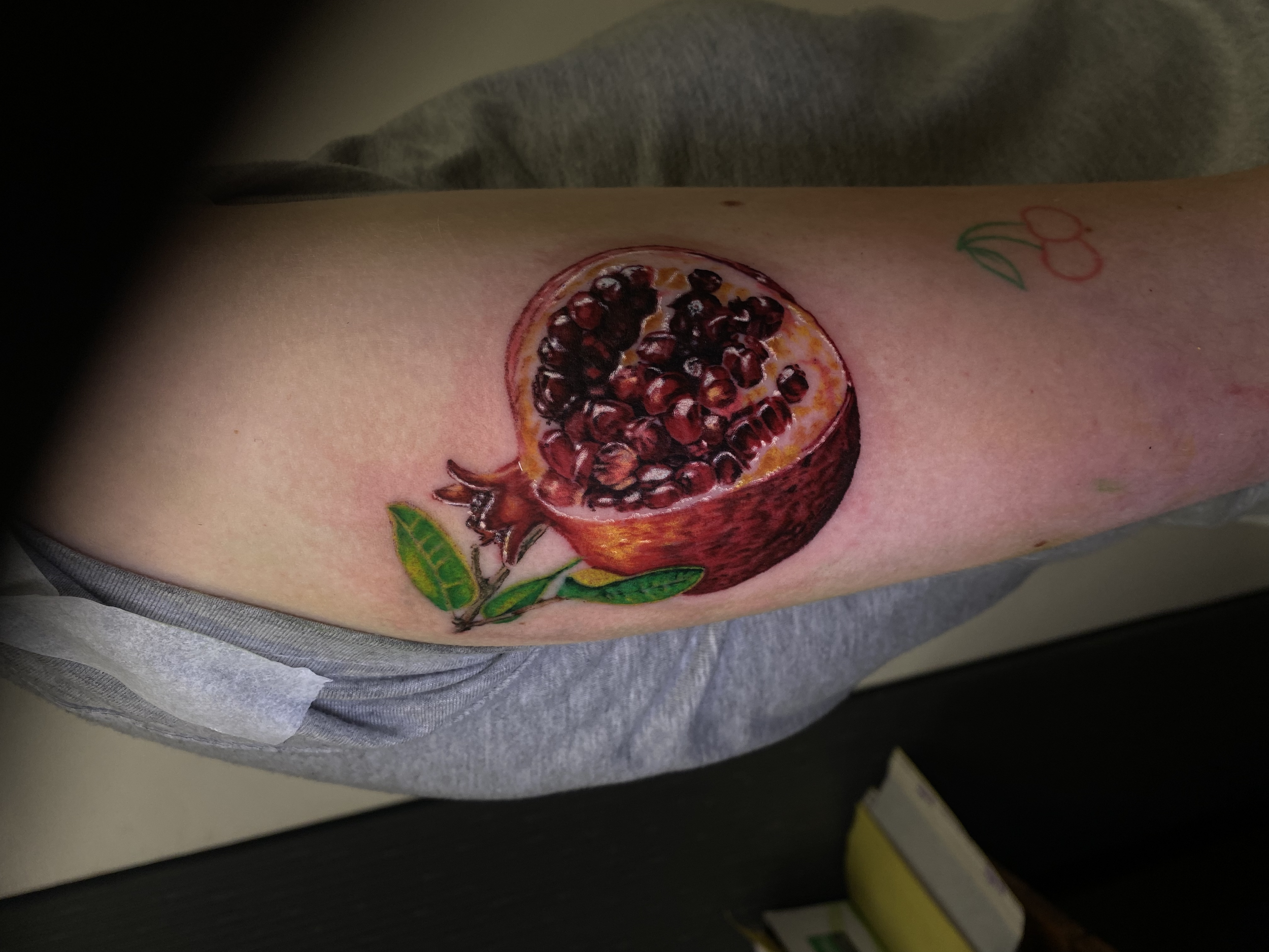 pomegranate tattoo full color realism tattoo done by kim bale at banjaxed ink irelands best tattoo studio