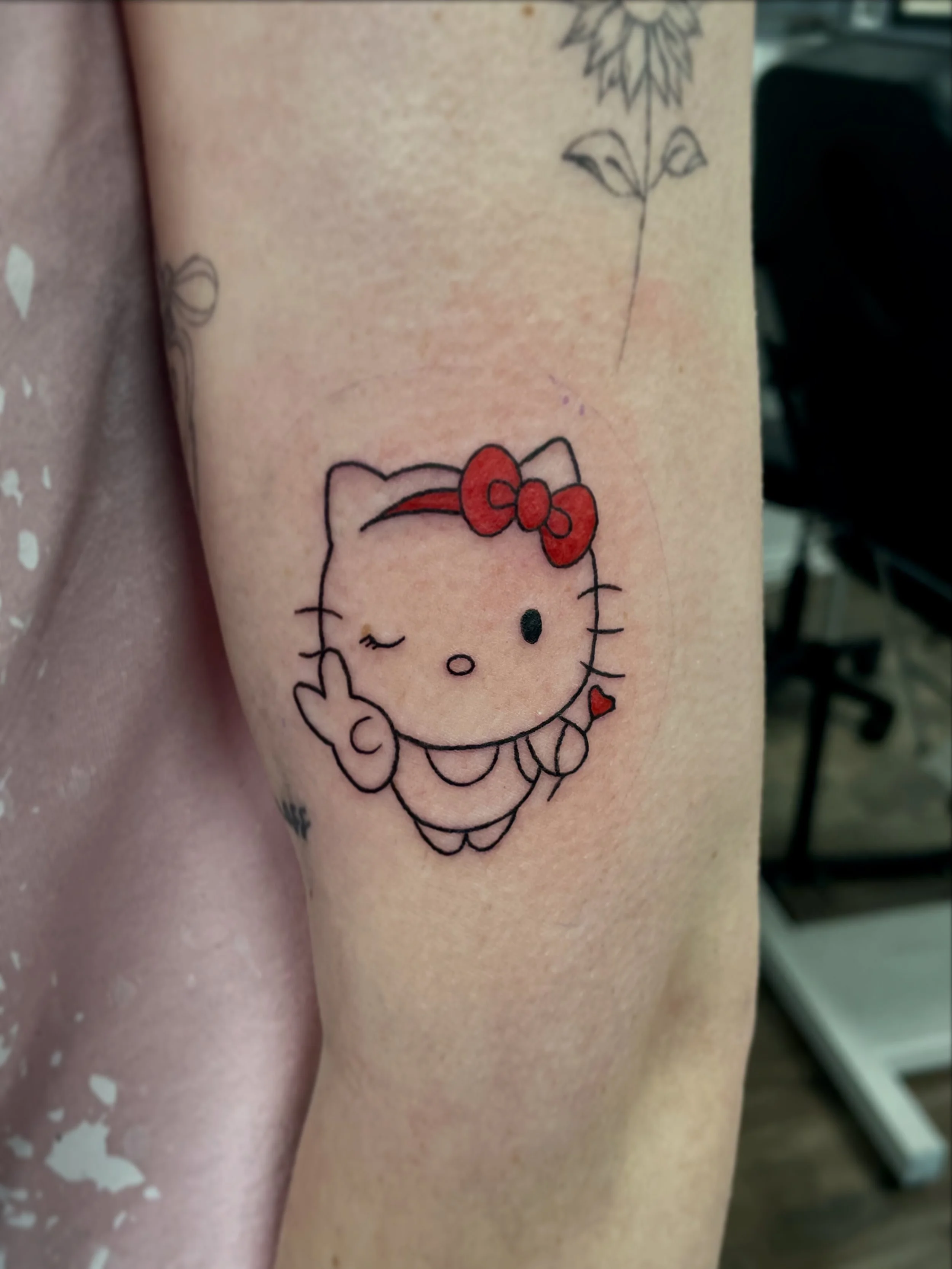 Cute fineline hello kitty tattoo done by ceidi corbally at banjaxed ink tattoo studio dublin ireland fine line
