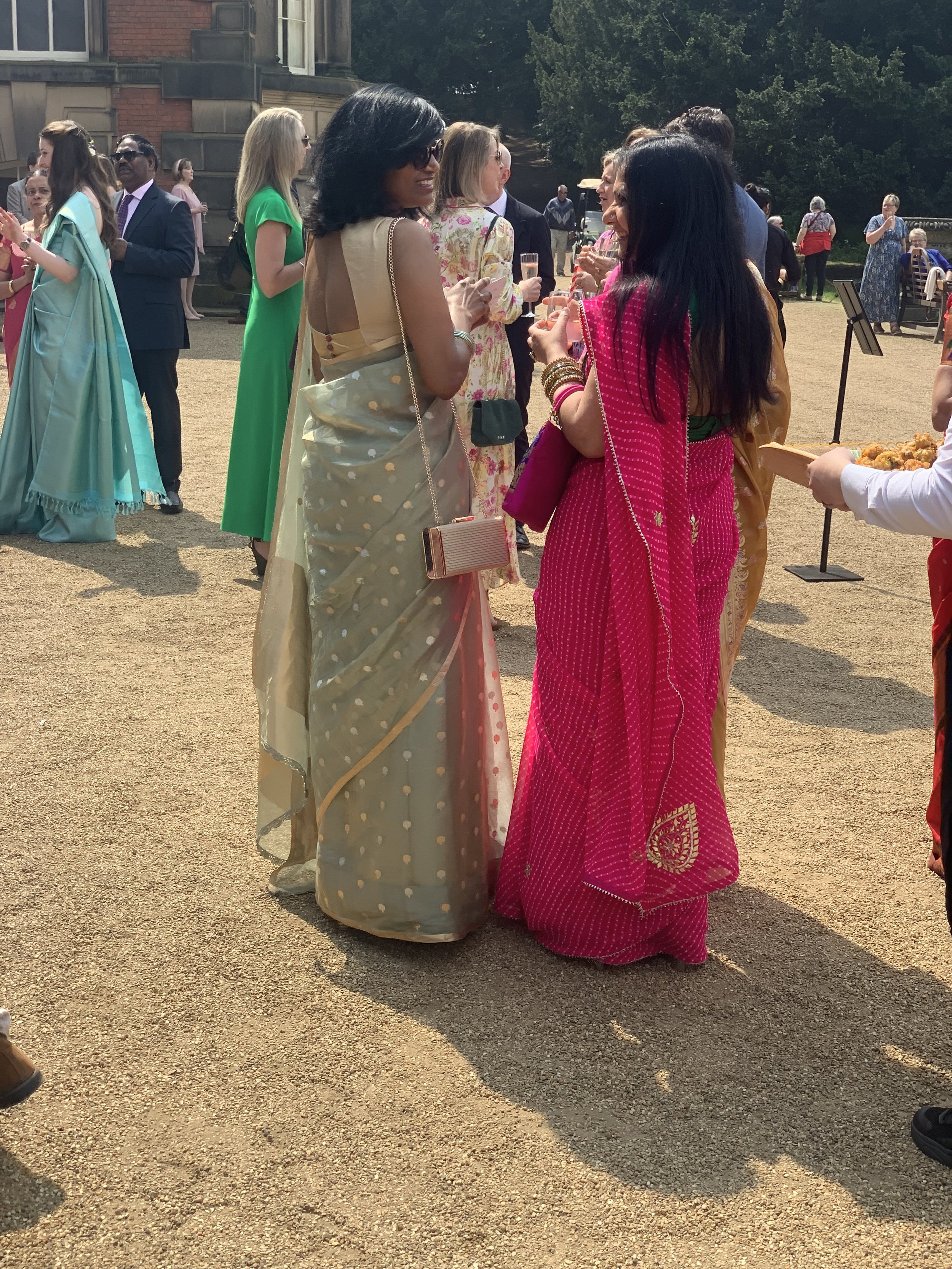 Two wedding guests at Wentworth Woodhouse. They are dressed in colourful religious dress.