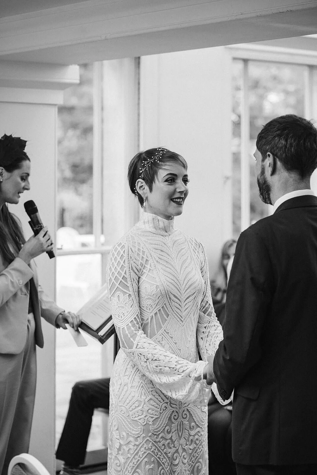 A bride and groom stand with Michelle Park Celebrant who honours the loss of loved ones on their wedding day