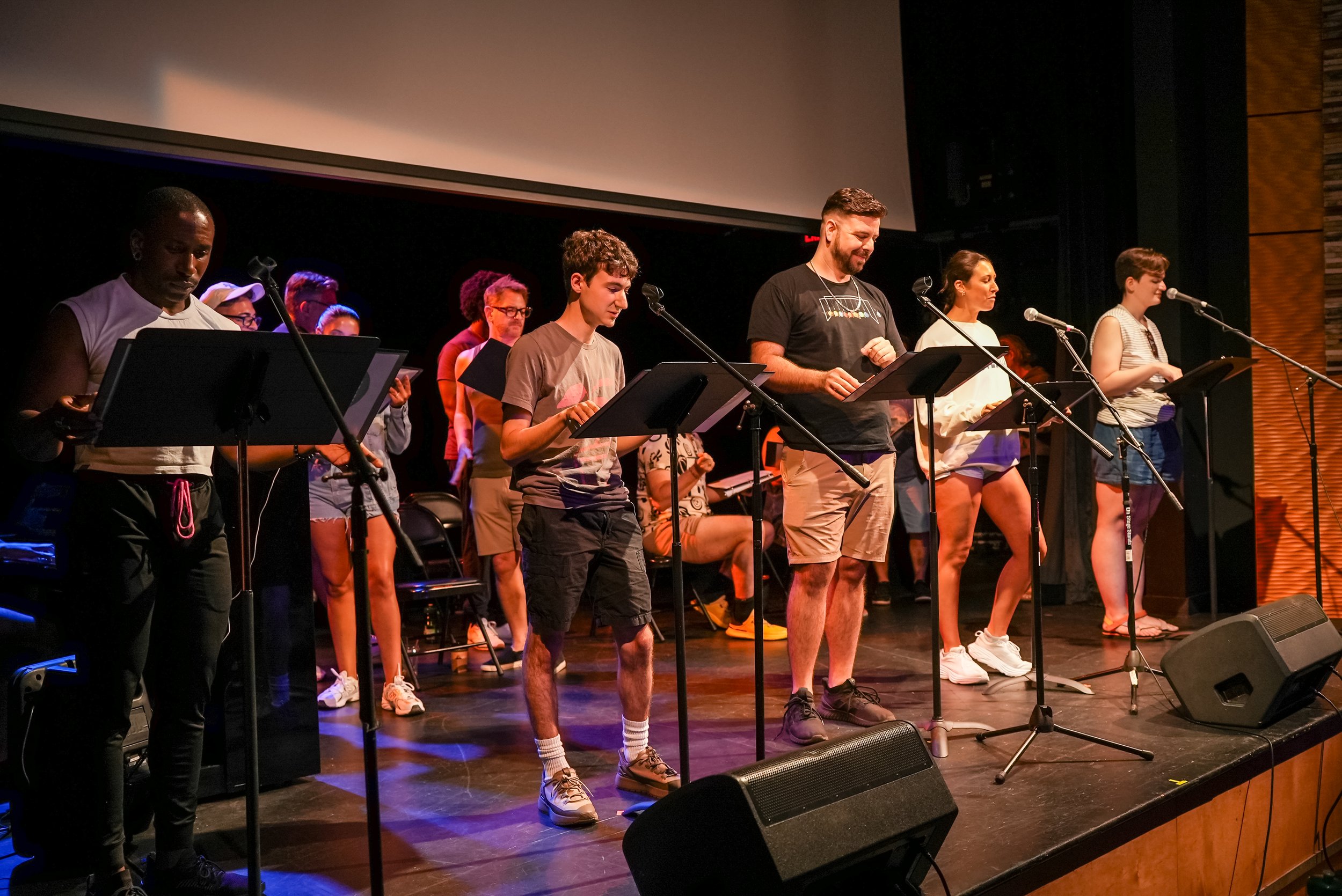 Actors on stage in position rehearsing