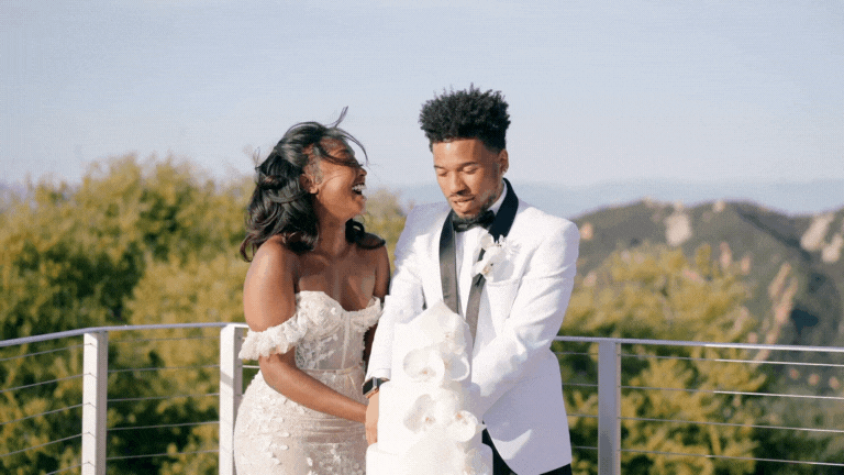 bride and groom smiling at each other