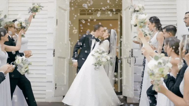 couple leaving church after getting married with bubbles in the air