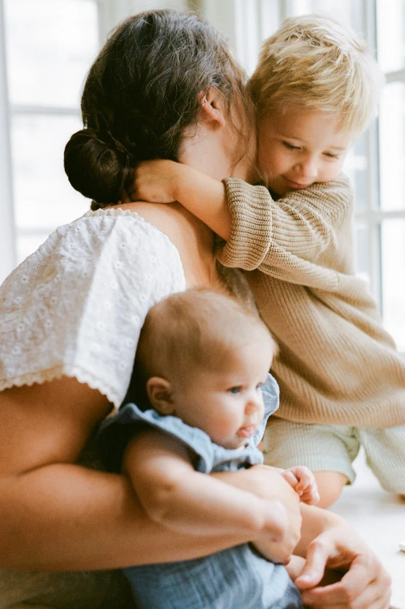 intimate-motherhood-photography-baby-preschooler-hugging-mom-neck-greensboro