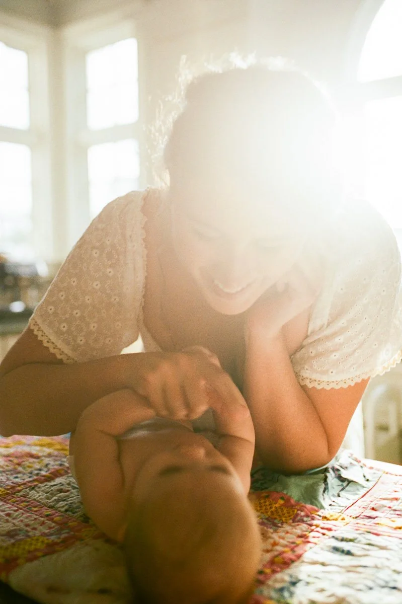 intimate-in-home-family-session-baby-after-bath-mom-smiling-nc