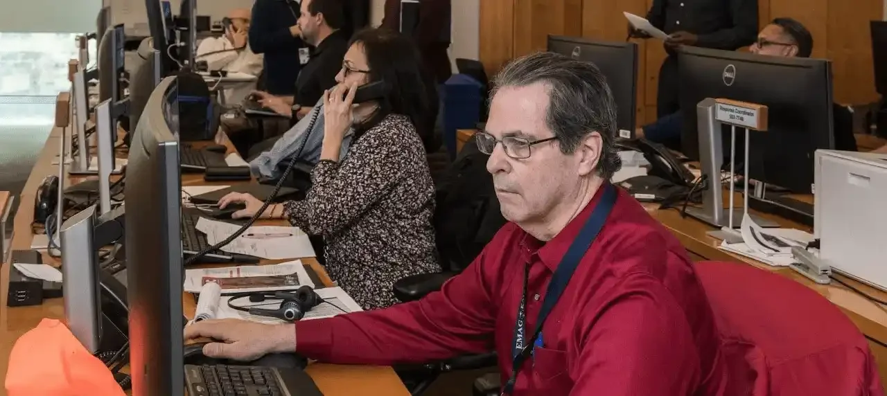 People on phones and computers in a call center