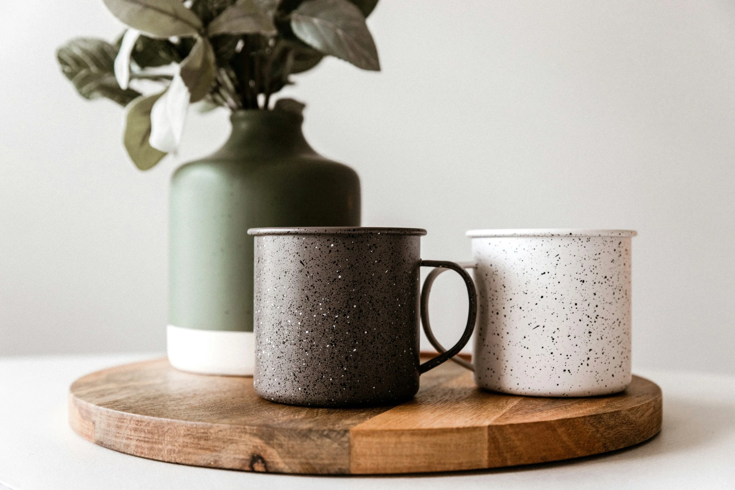 Two coffee mugs on a wooden board in a sunlit room, illustrating relational depth, communication skills, and building authentic connections.