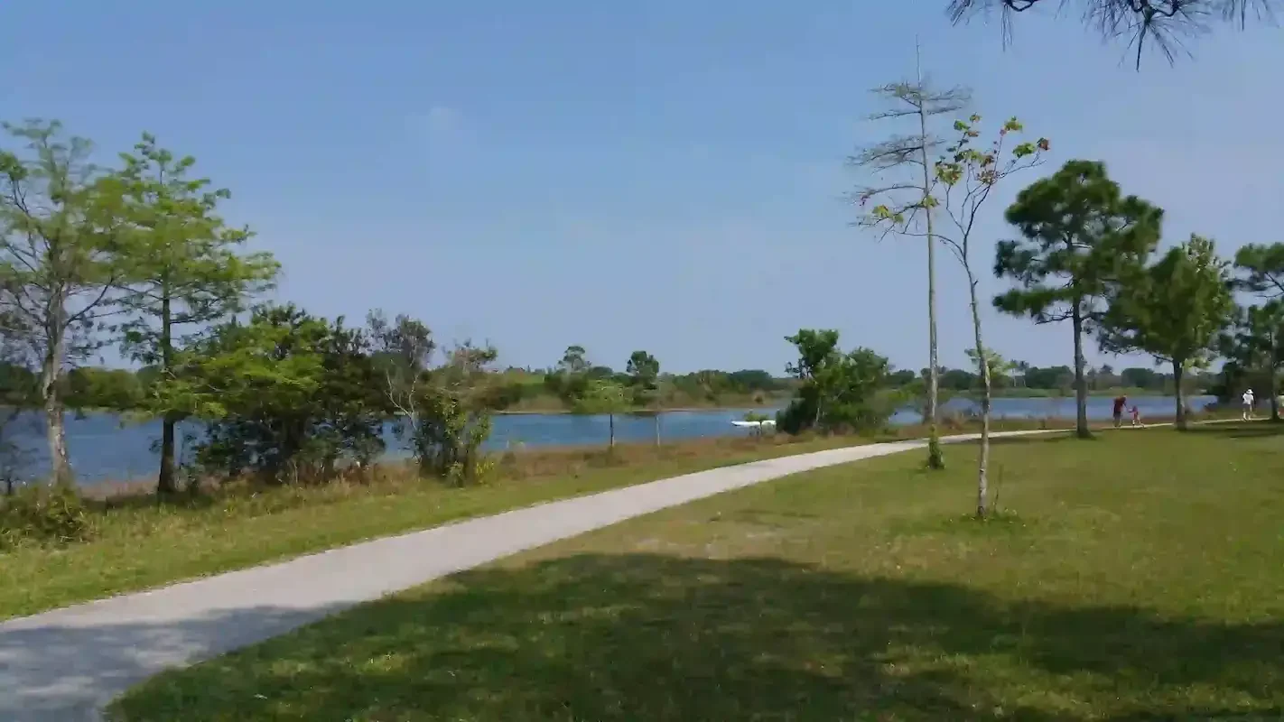 A winding lakeside path through Okeeheelee Park in Palm Beach County, Florida, reflecting the journey of recovery, growth, and moving forward.