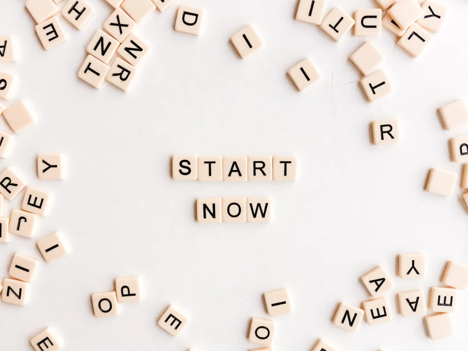 Tile letters spell out START NOW.