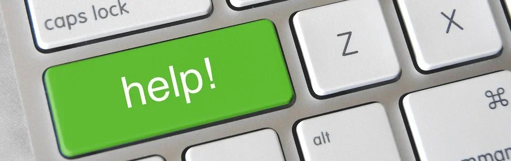 a computer keyboard shows a green key with the word Help!.jpg