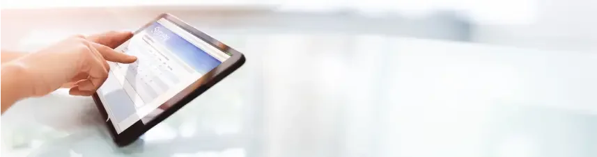 A person uses their finger to fill out therapy intake forms on a tablet.