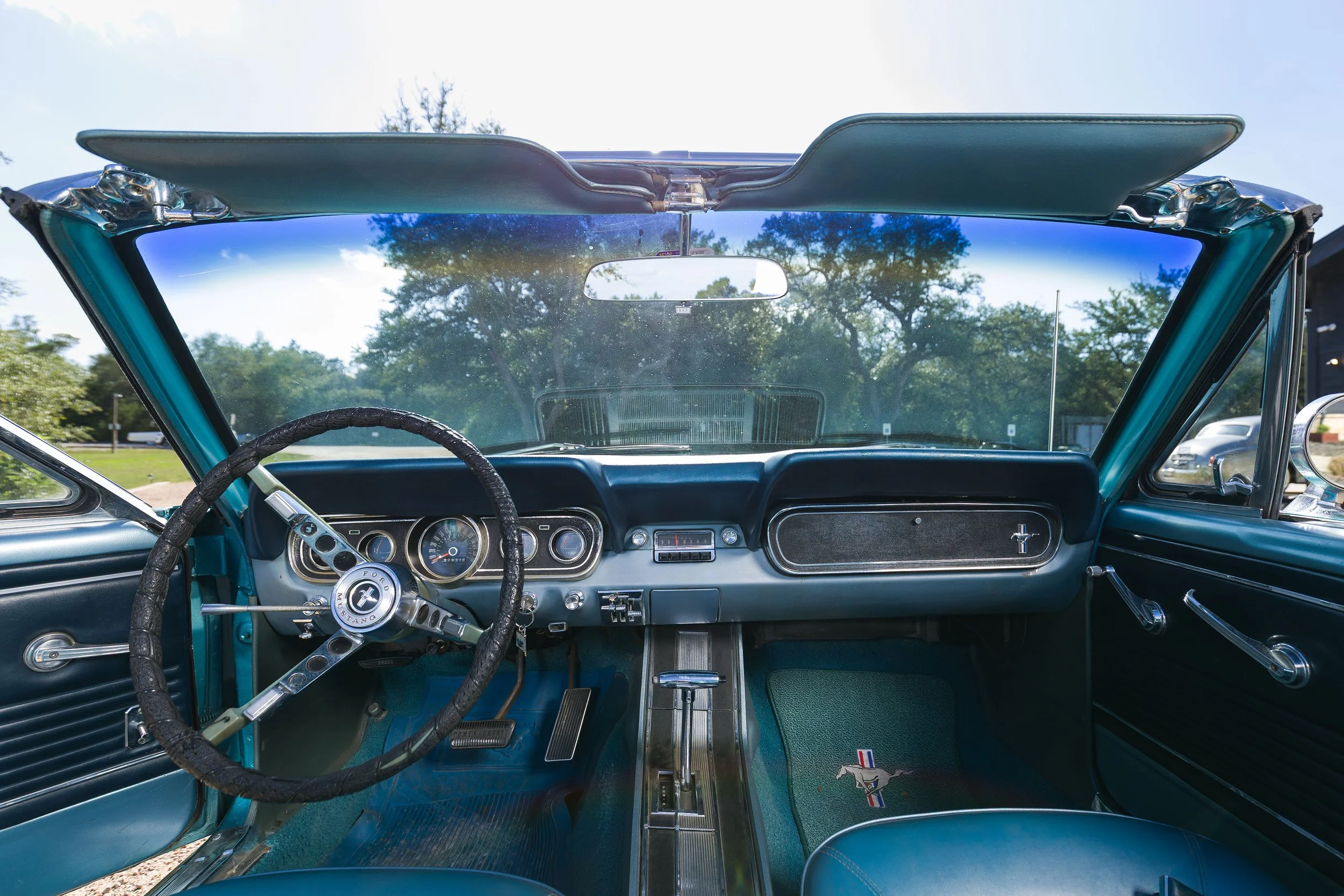 Blue interior and dashboard of a 1966 Mustang convertible seen from the front